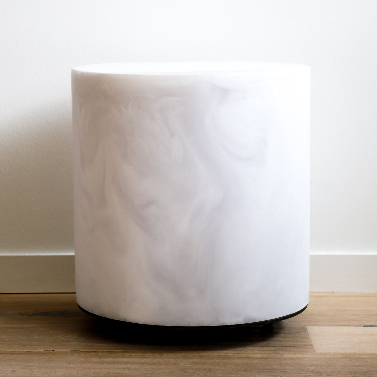 Chief round stool in a white marble finish made of resin with steel castors by Martha Sturdy