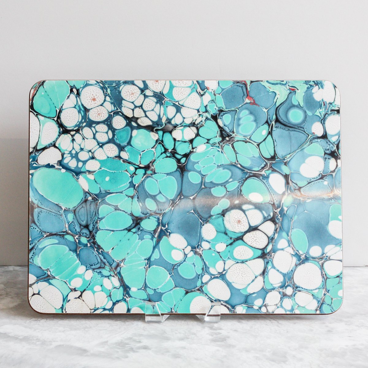 Placemats in emerald echo of blues and teals made of eucalyptus board by Studio Formata