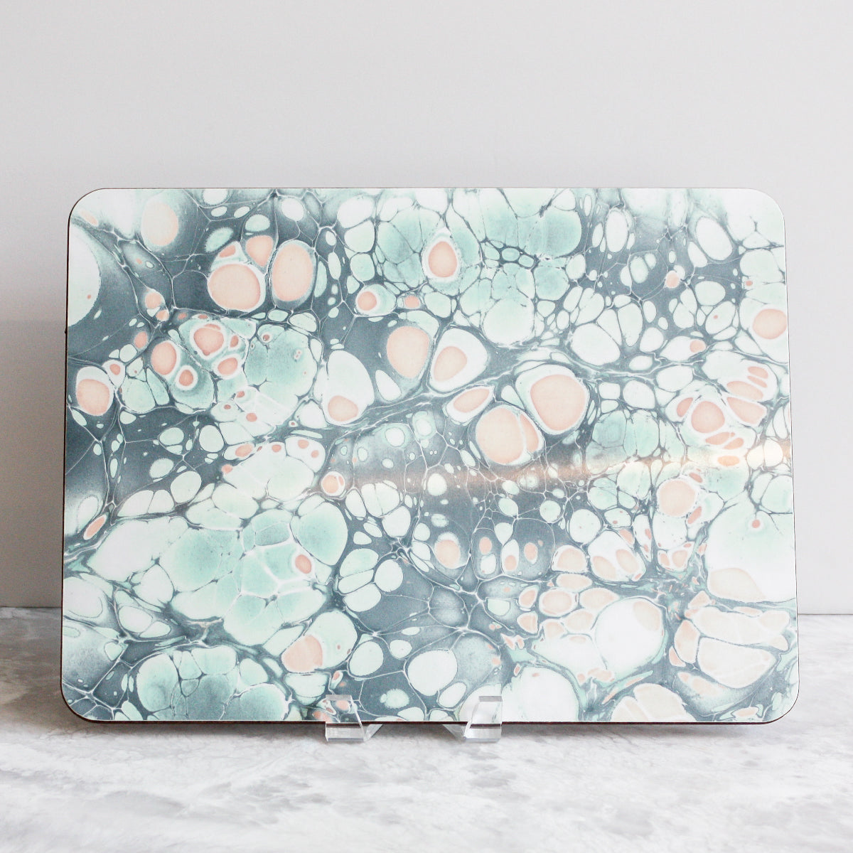 Placemats in soft islands of pinks, blues, greens and grays made of eucalyptus board by Studio Formata