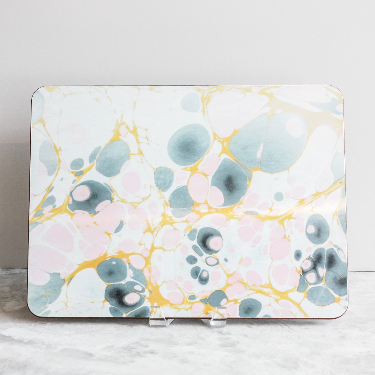 Placemats in solar tides of yellows, pinks and grays made of eucalyptus board by Studio Formata