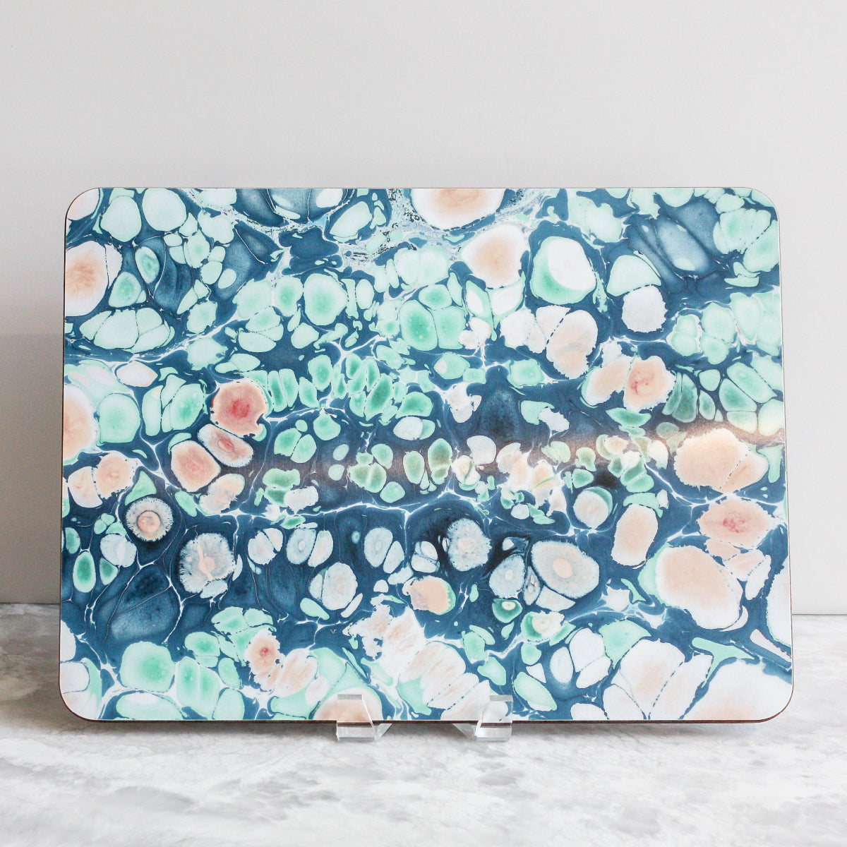 Placemats in spring blossoms of pinks, blues, greens and grays made of eucalyptus board by Studio Formata