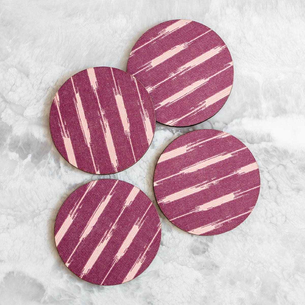 Ikat coasters made of cork and wood in purple by Tisch New York