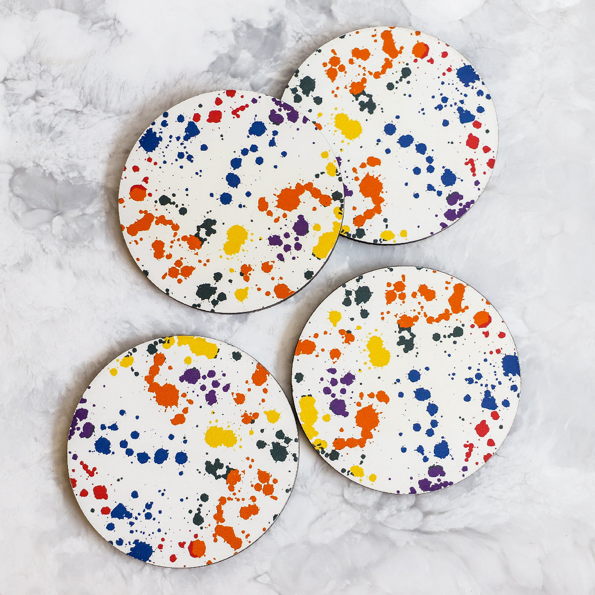 Printed Coasters with Splatter pattern in yellow, orange, blue and green made of cork and wood by Tisch New York